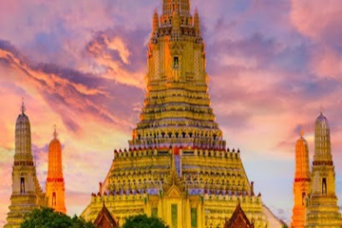 Wat Arun central prang rising above the Chao Phraya at golden hour