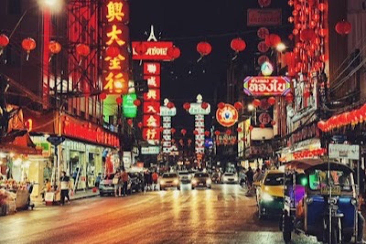 Yaowarat Road neon signs and sizzling street-food stalls in Bangkok's Chinatown at night