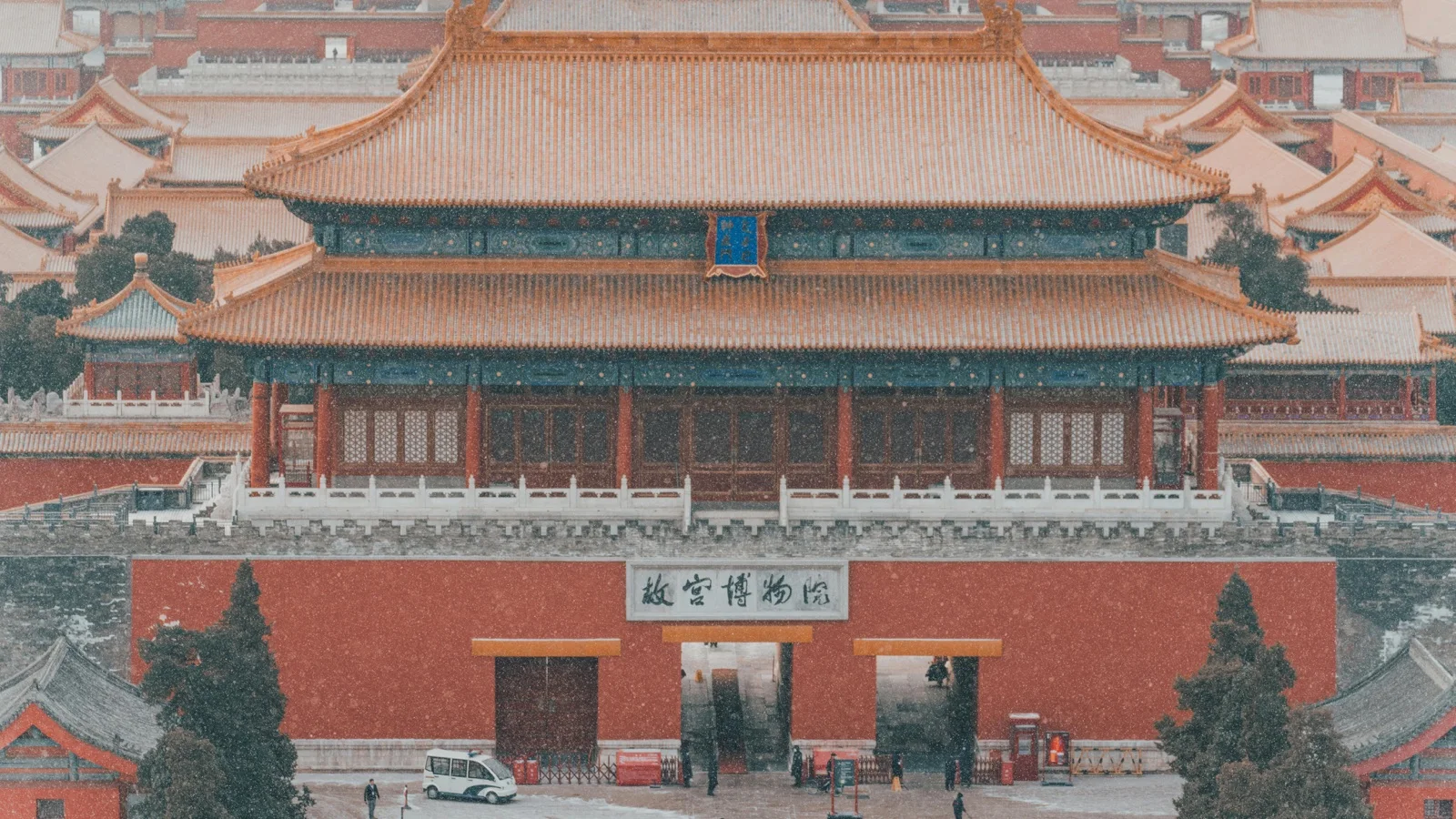 Winter view of the Forbidden City with golden rooftops and clear sky over the imperial courtyards