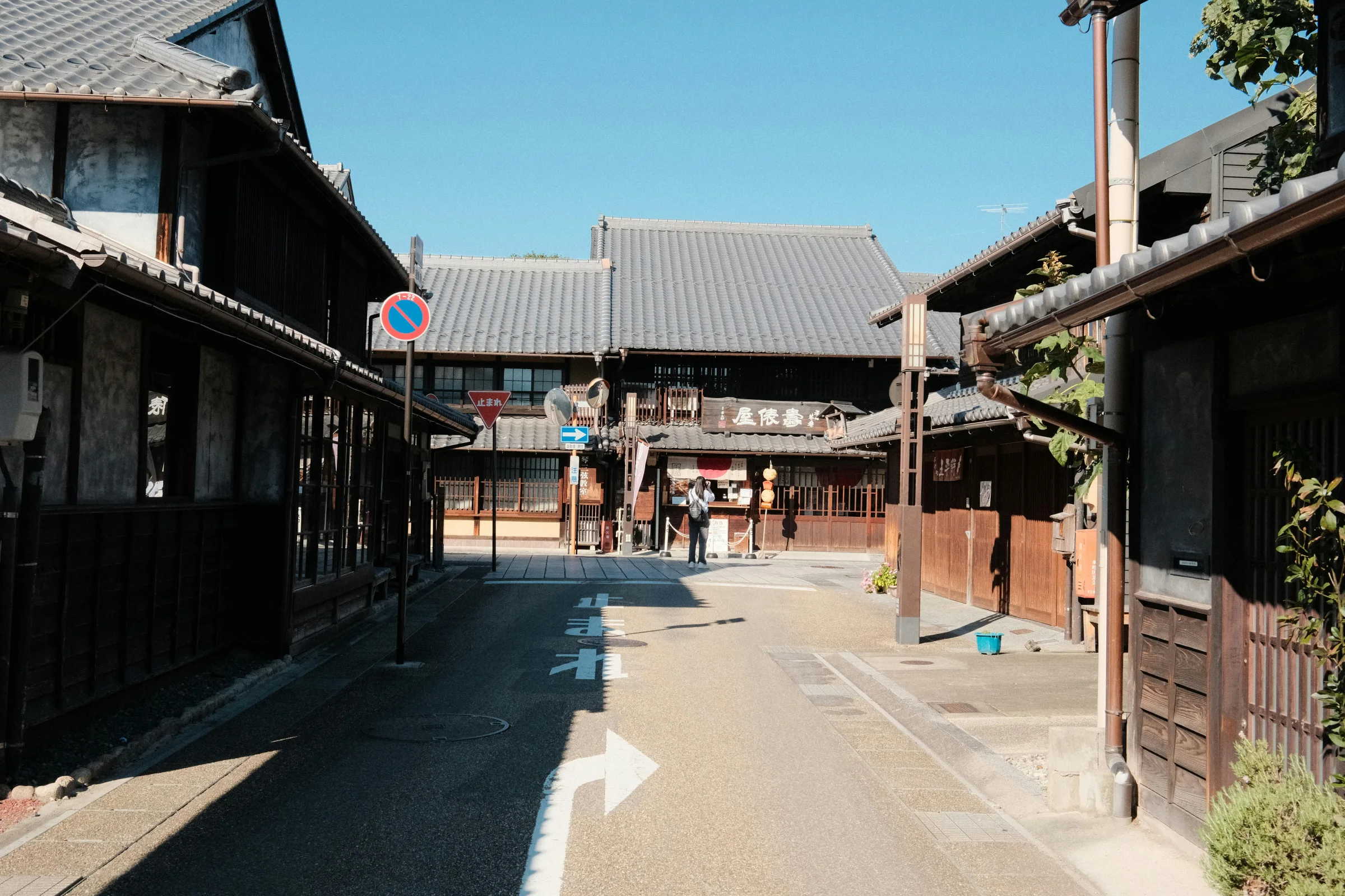 Street scene in Beppu, Japan with steam from hot springs and mountains in the background