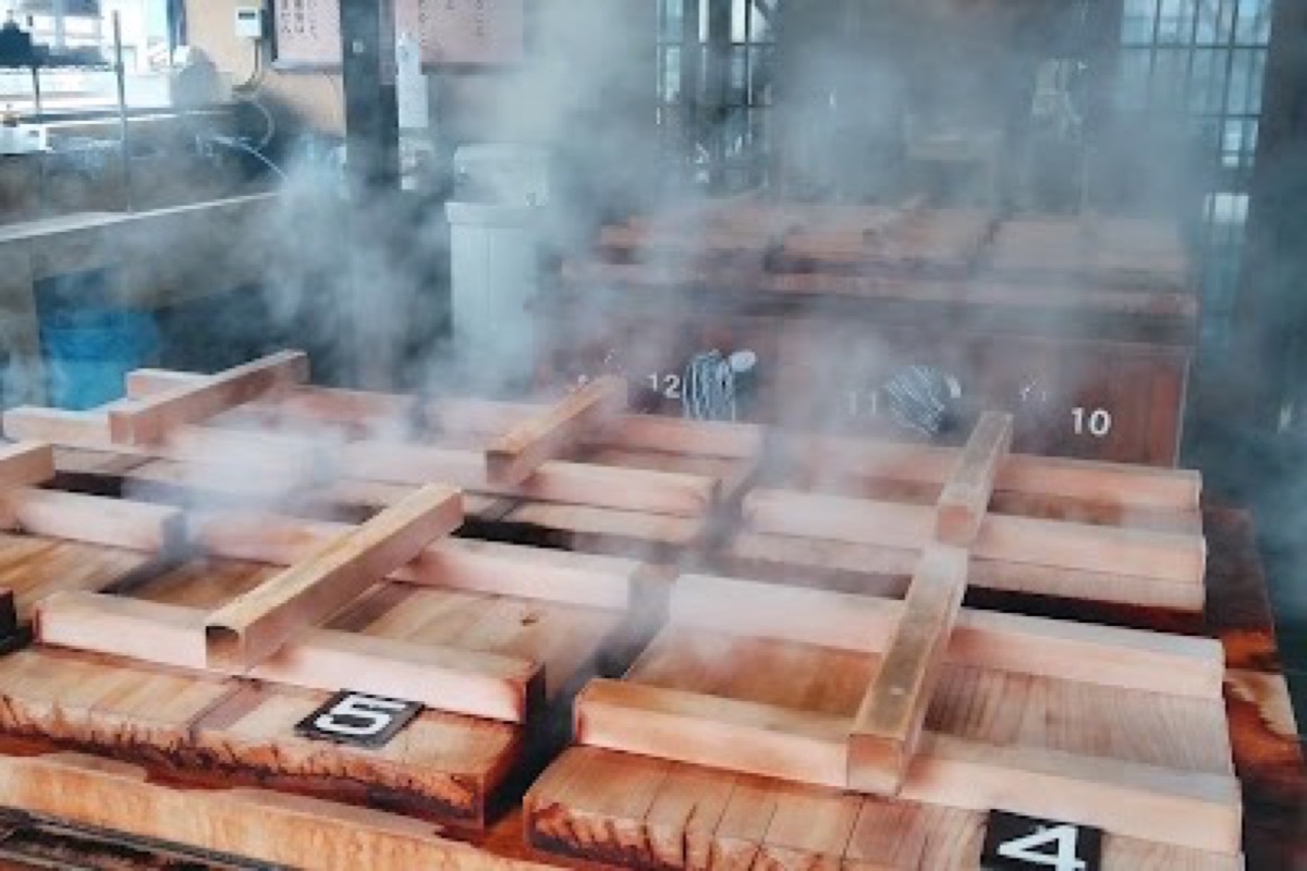Jigoku Mushi Kobo steam cooking boxes with geothermal vents in Kannawa, Beppu