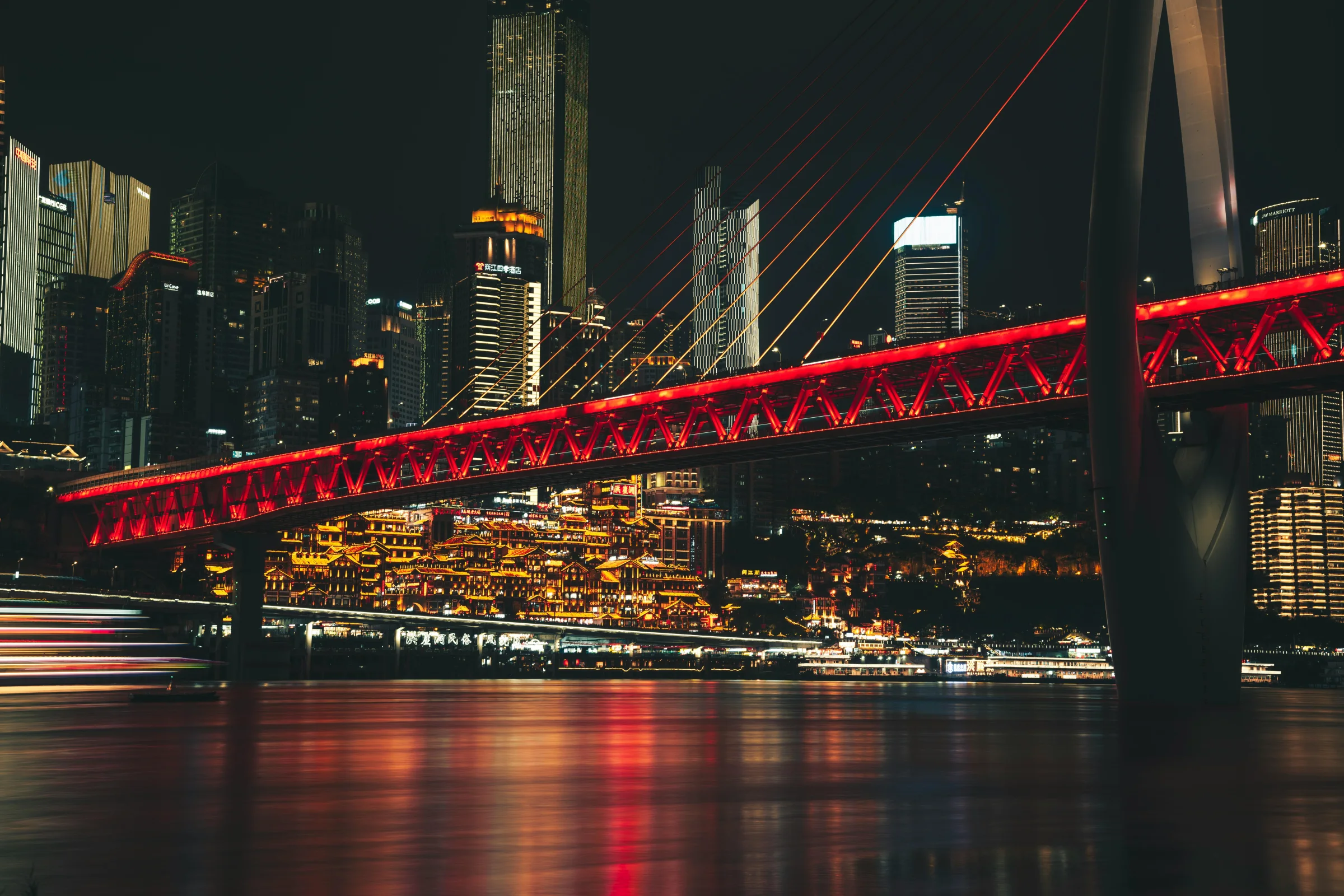 Night view of Chongqing skyline along the Yangtze River with illuminated buildings and reflections