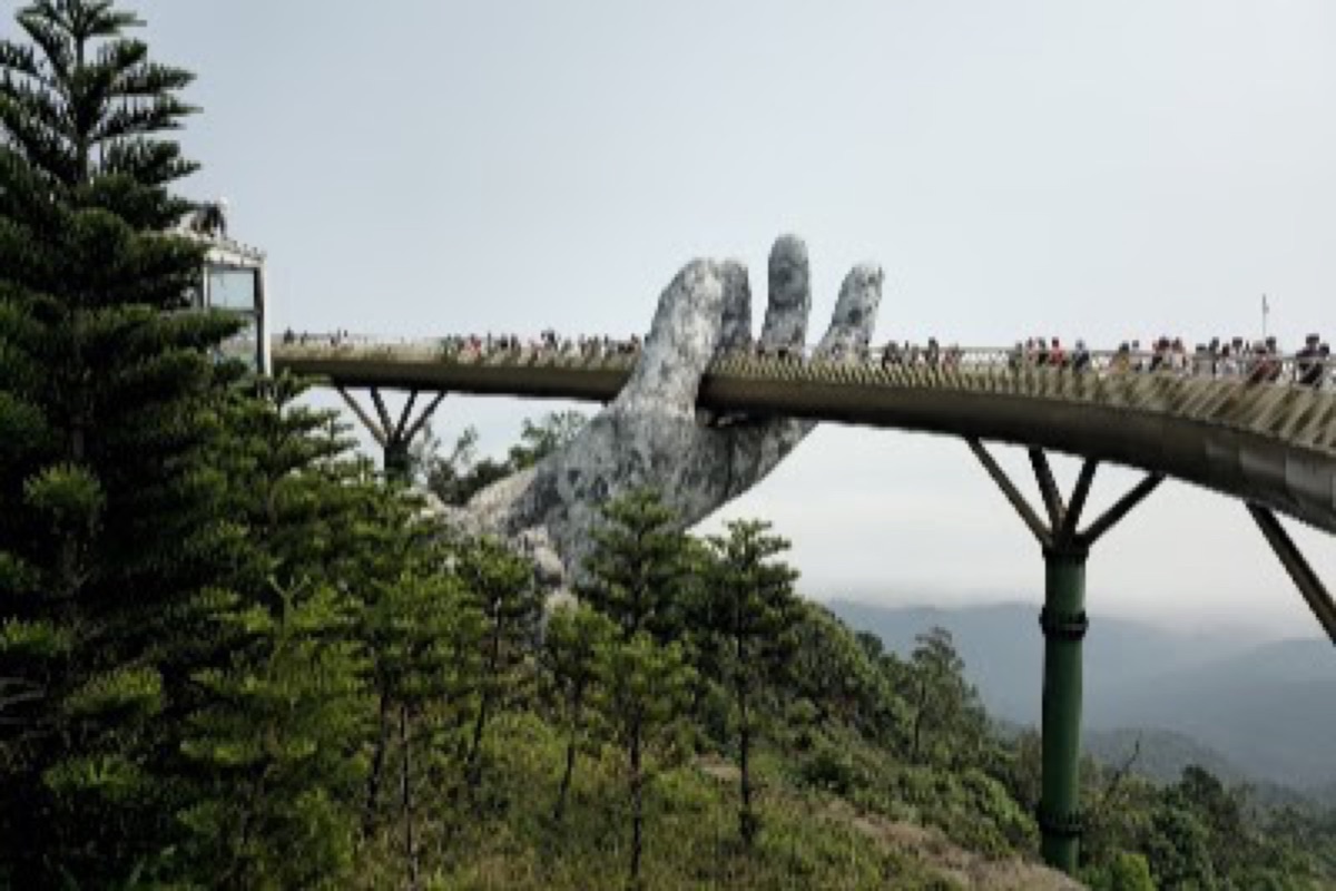 Ba Na Hills cable car cabins rising over the forest toward the French village summit