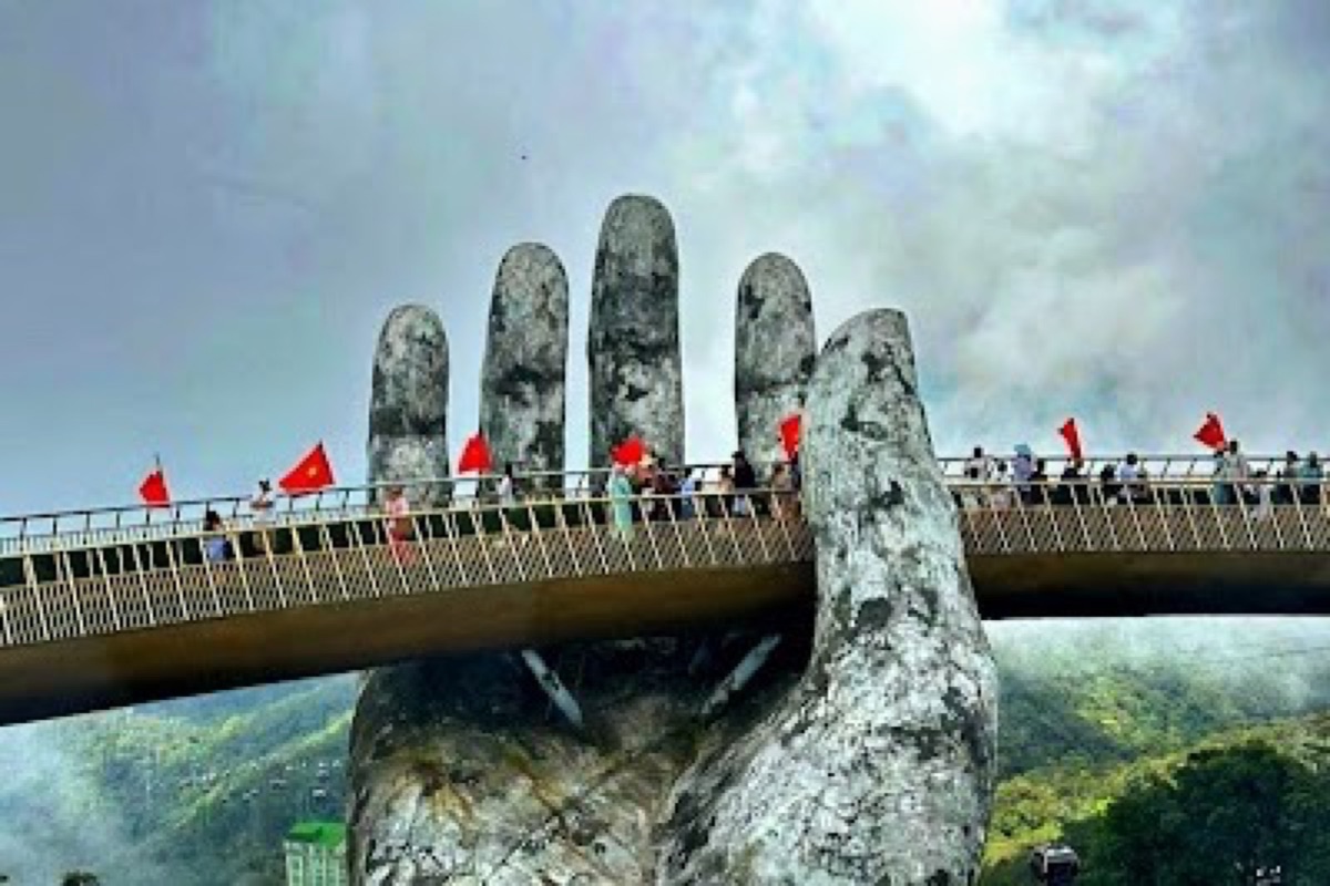 Giant stone hands lifting the Golden Bridge walkway above the Ba Na Hills gardens