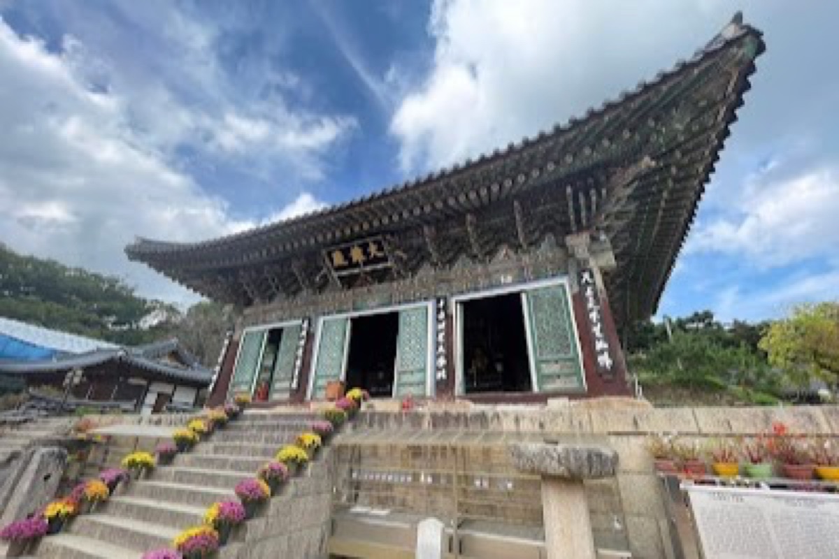 Donghwasa Temple stone Buddha courtyard with autumn foliage on Palgongsan slopes in Daegu