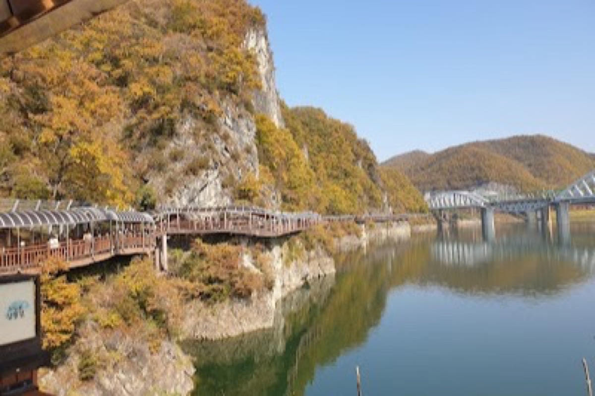 Danyanggang Jando Trail cliffside boardwalk above the Namhangang River at golden hour in Danyang