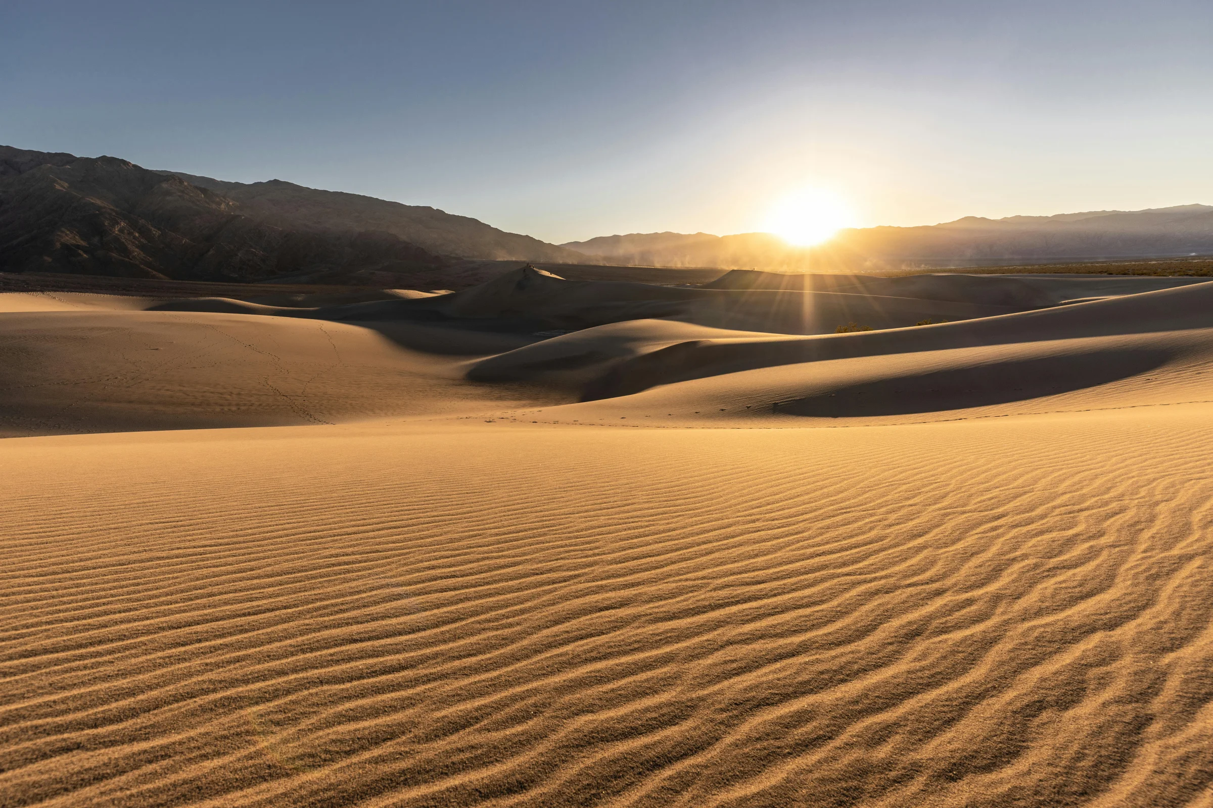 Wide desert landscape in Death Valley National Park at golden hour