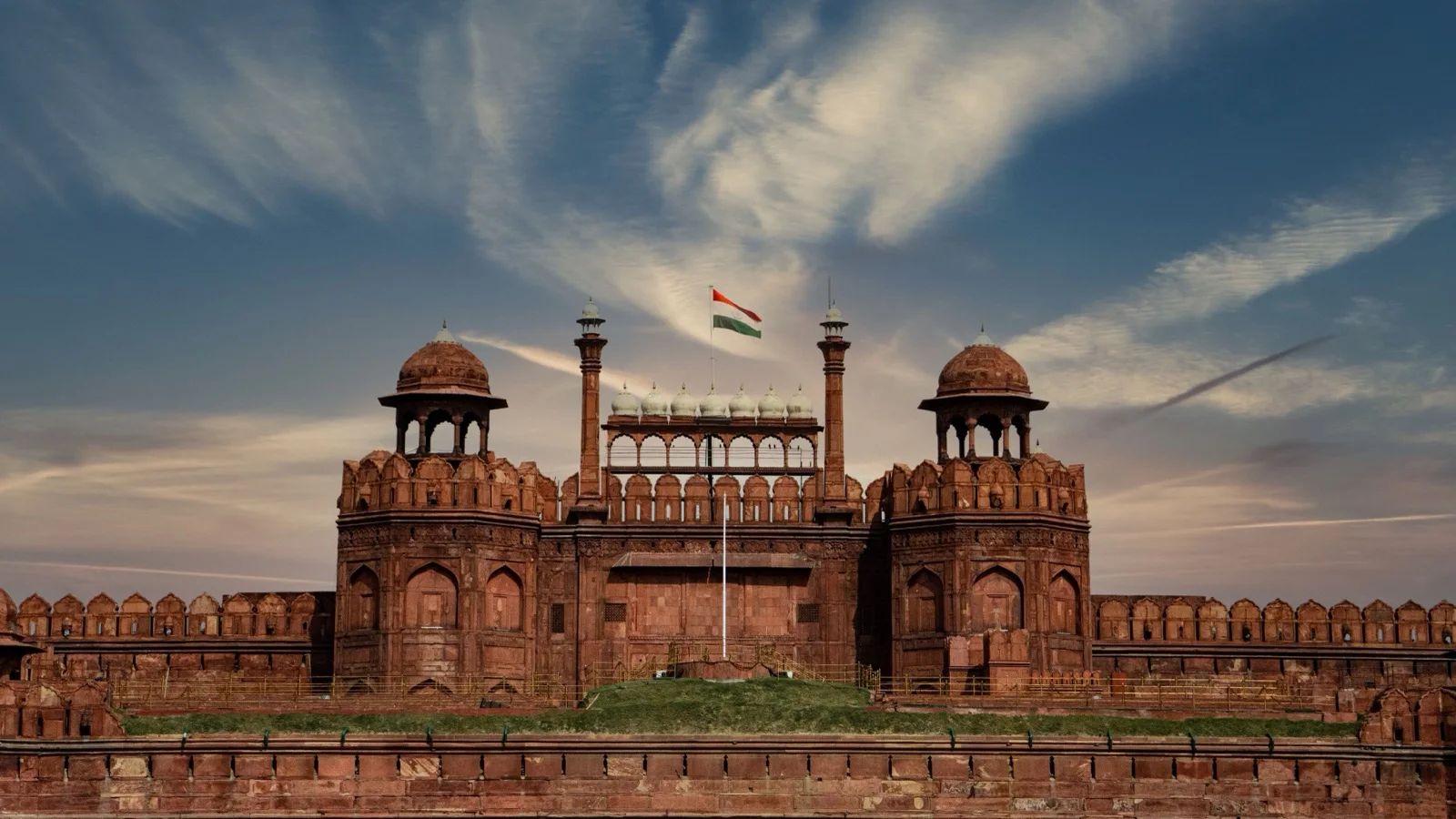 The red sandstone walls and Lahori Gate of the Red Fort rising above the old streets of Delhi