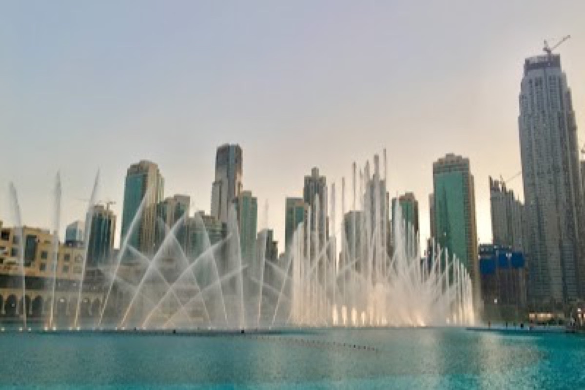 Dubai Fountain show lit up at night on Burj Lake below the Downtown towers