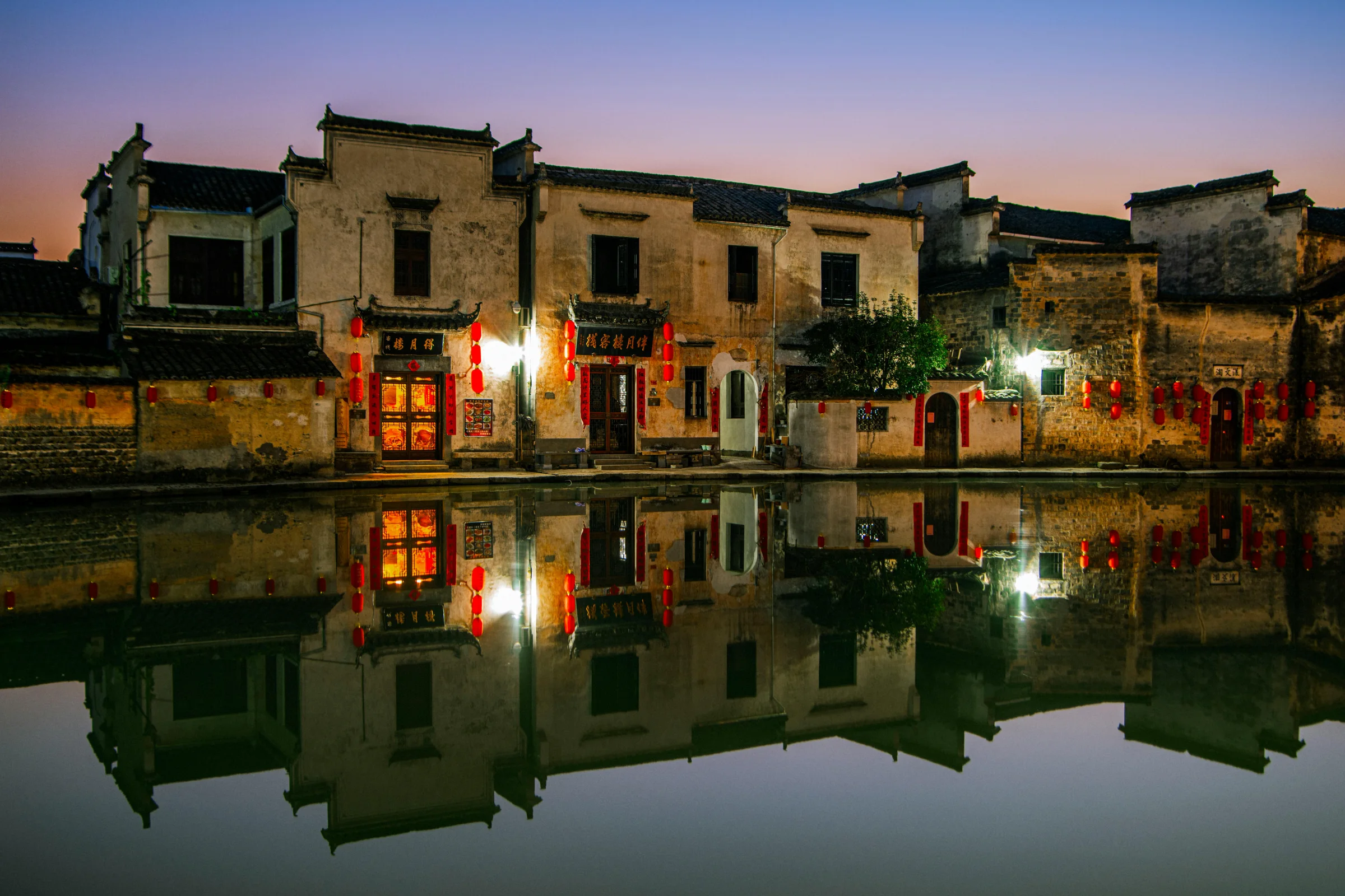 Dusk street scene in Foshan, China with warm lantern lights and traditional architecture