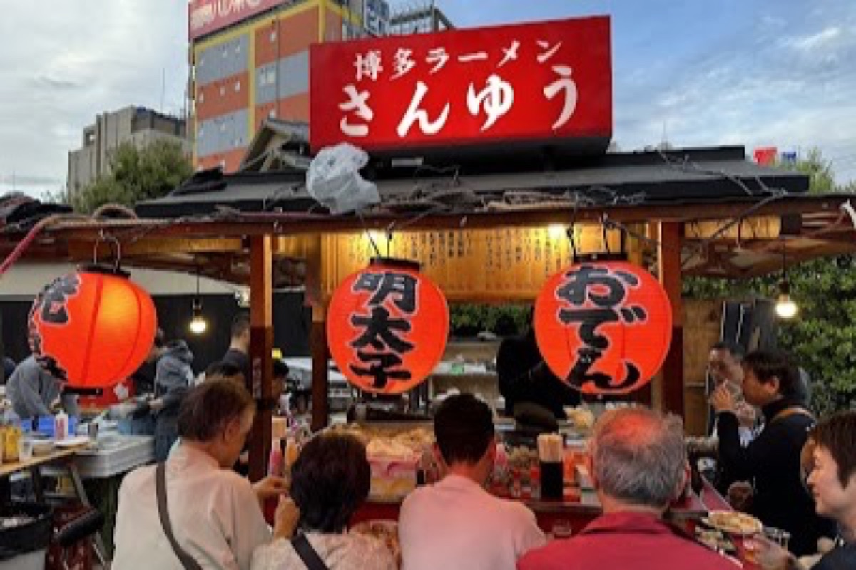Nakasu yatai food stalls lit up at night along the Naka River in Fukuoka