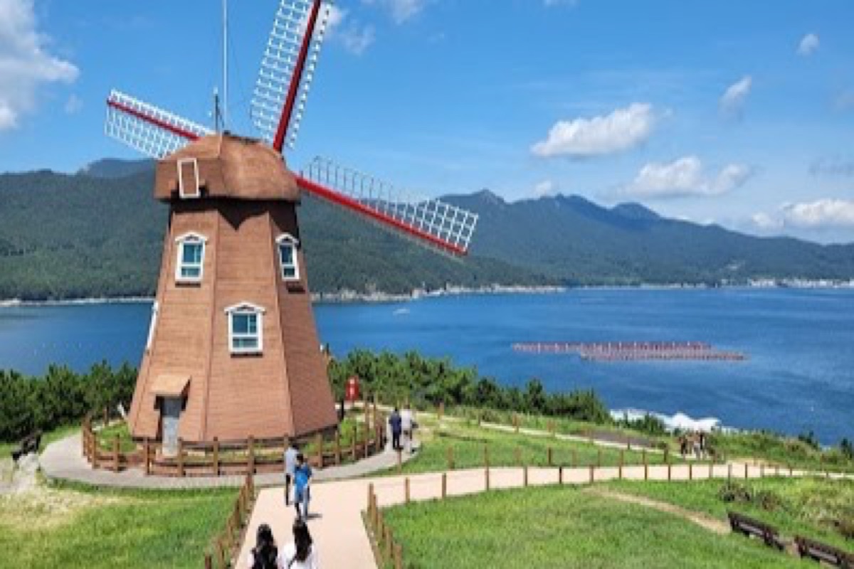 Windy Hill Dutch-style windmill overlooking the southern coastline and Hallyeohaesang Archipelago at golden hour
