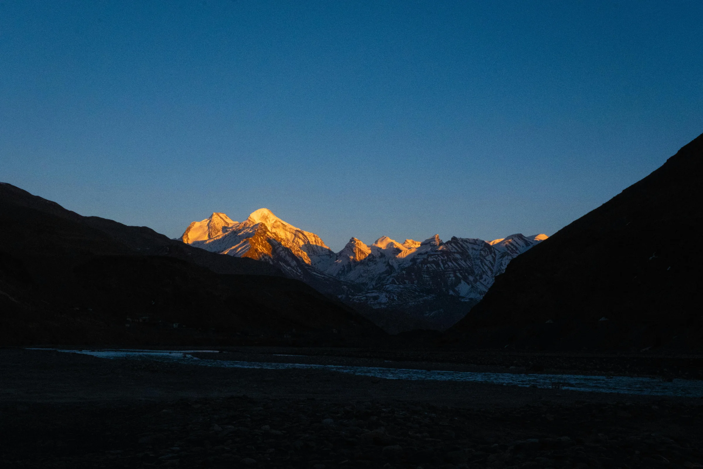 Wide hero view of Guadalupe Mountains desert peaks in Texas at golden hour under a clear sky