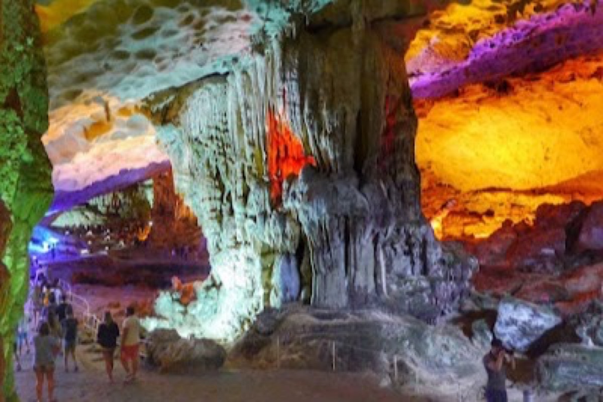 Stalactite chambers under colored lights inside Sung Sot Cave in Ha Long Bay