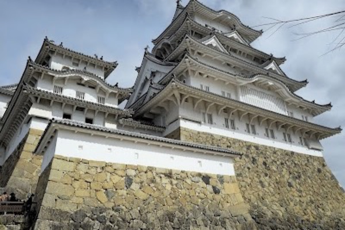 Himeji Castle's white wooden keep viewed from the castle approach path