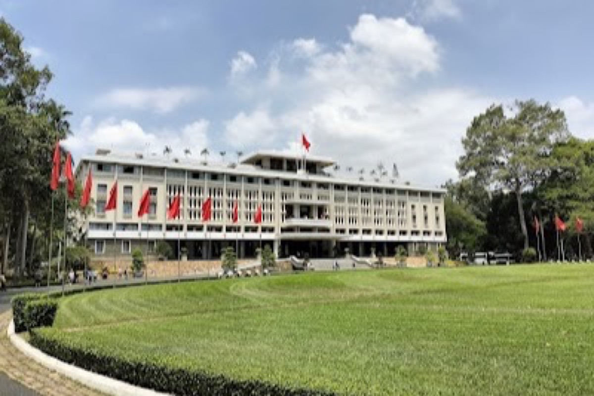 Independence Palace gates with replica tank and modernist facade in Saigon
