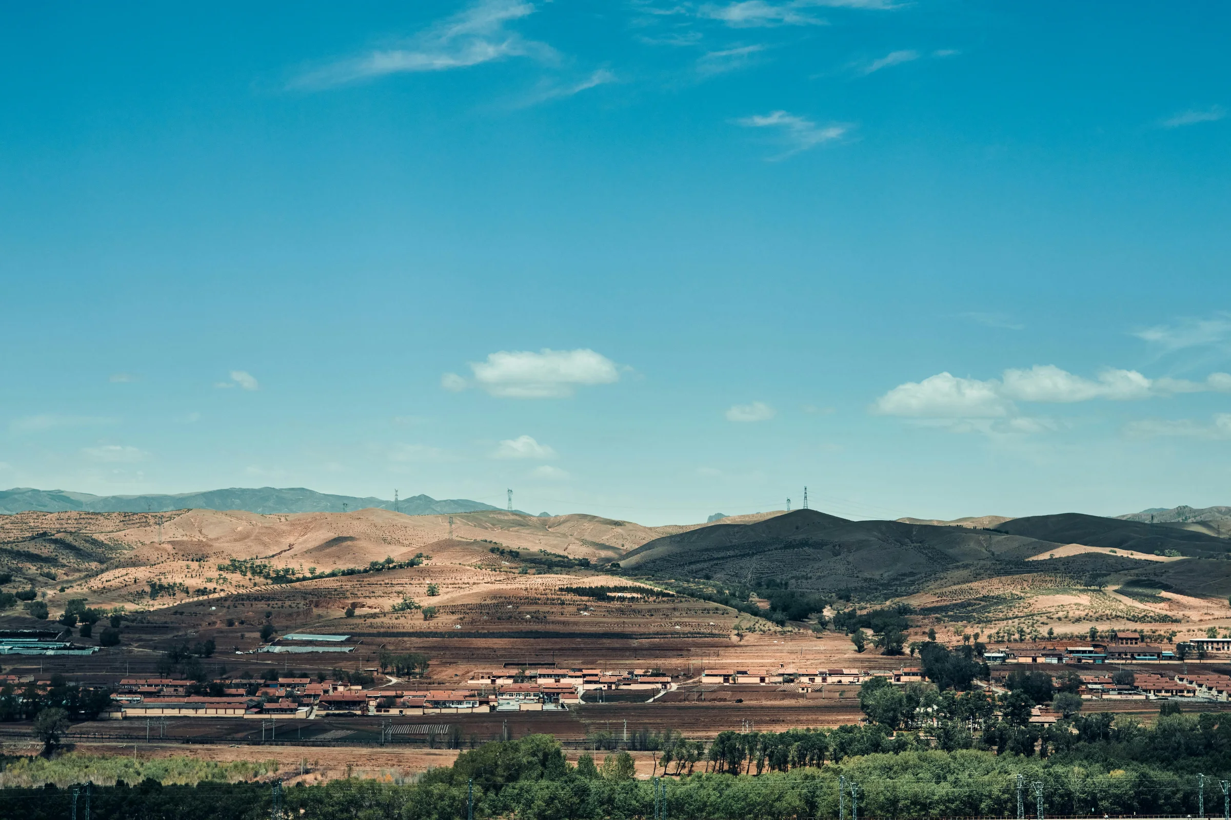 Golden-hour street scene with Hohhot city skyline in Inner Mongolia, China