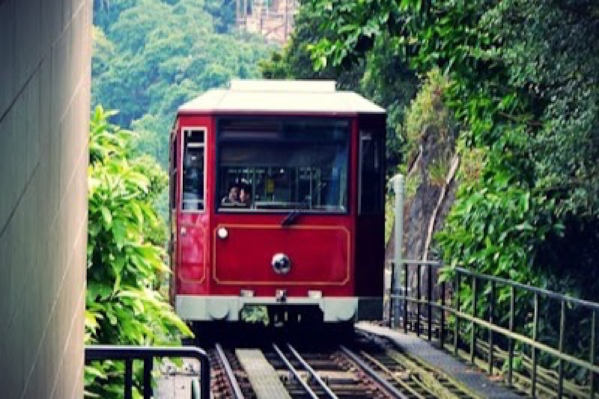 Peak Tram funicular ascending through the Mid-Levels toward Victoria Peak