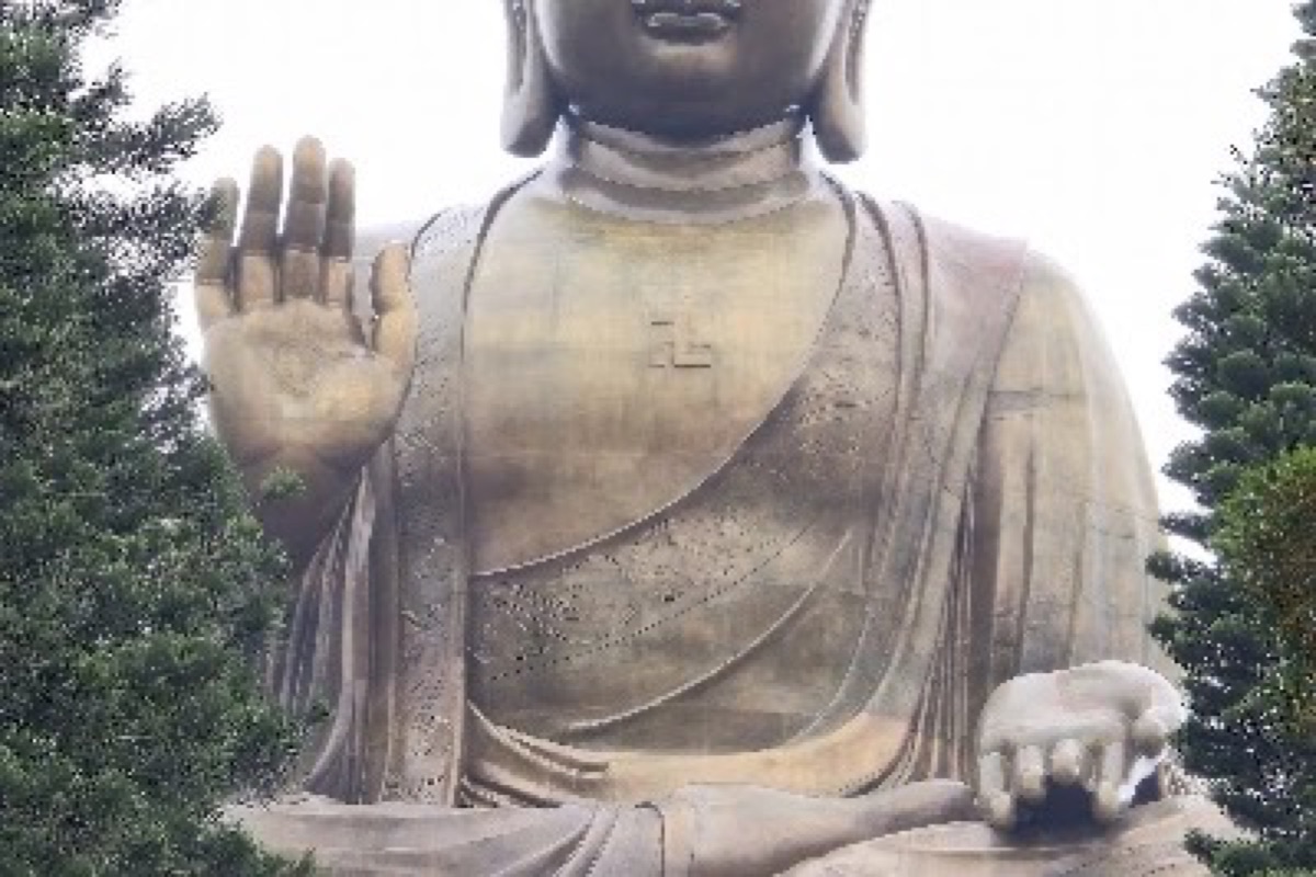 Tian Tan Buddha bronze statue overlooking Lantau Island mountains