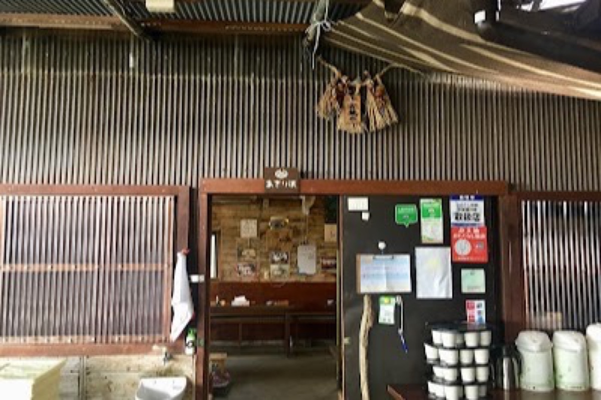 Ama divers grilling abalone over charcoal at a traditional seaside hut in Shima