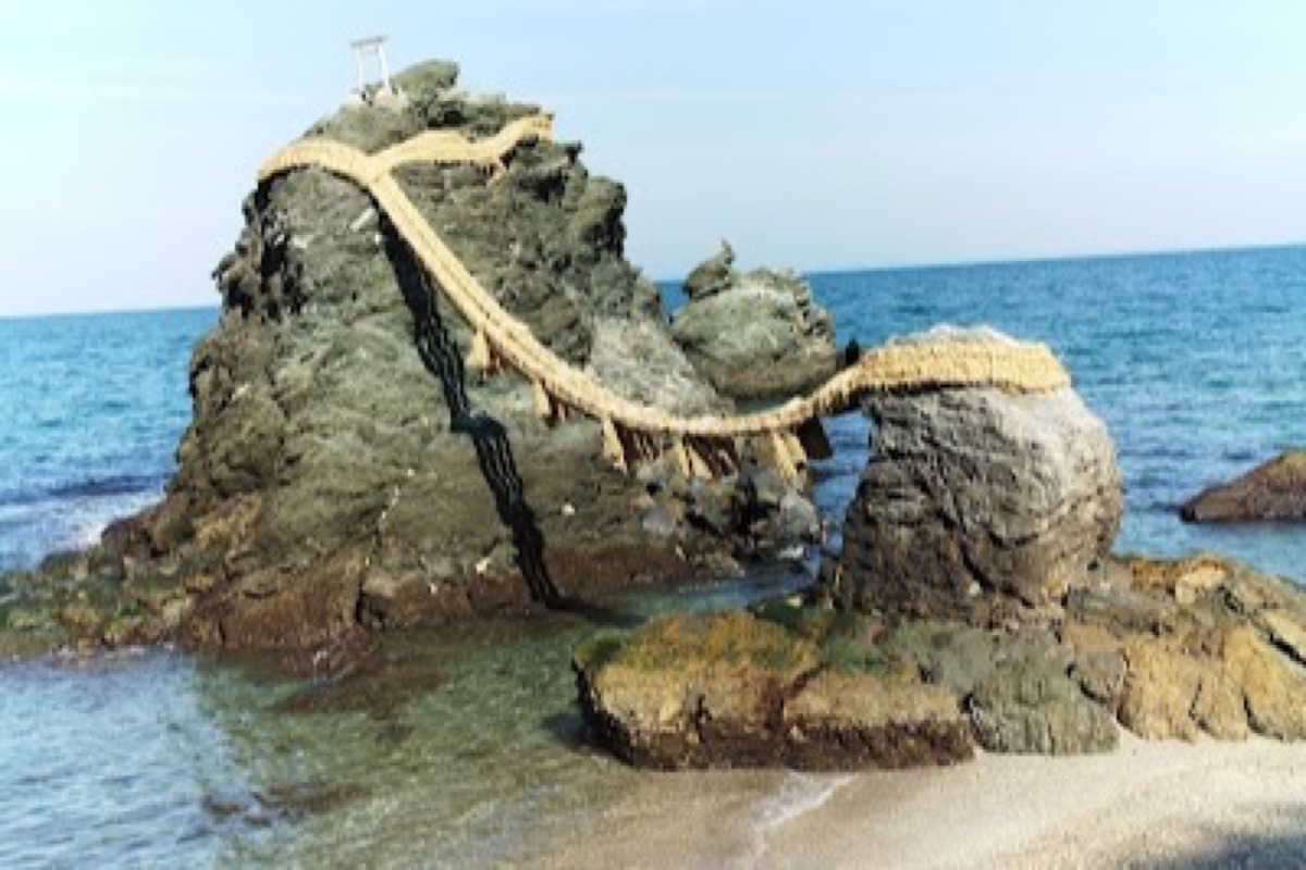 Meoto Iwa Wedded Rocks joined by shimenawa rope at sunrise over the Futami coastline