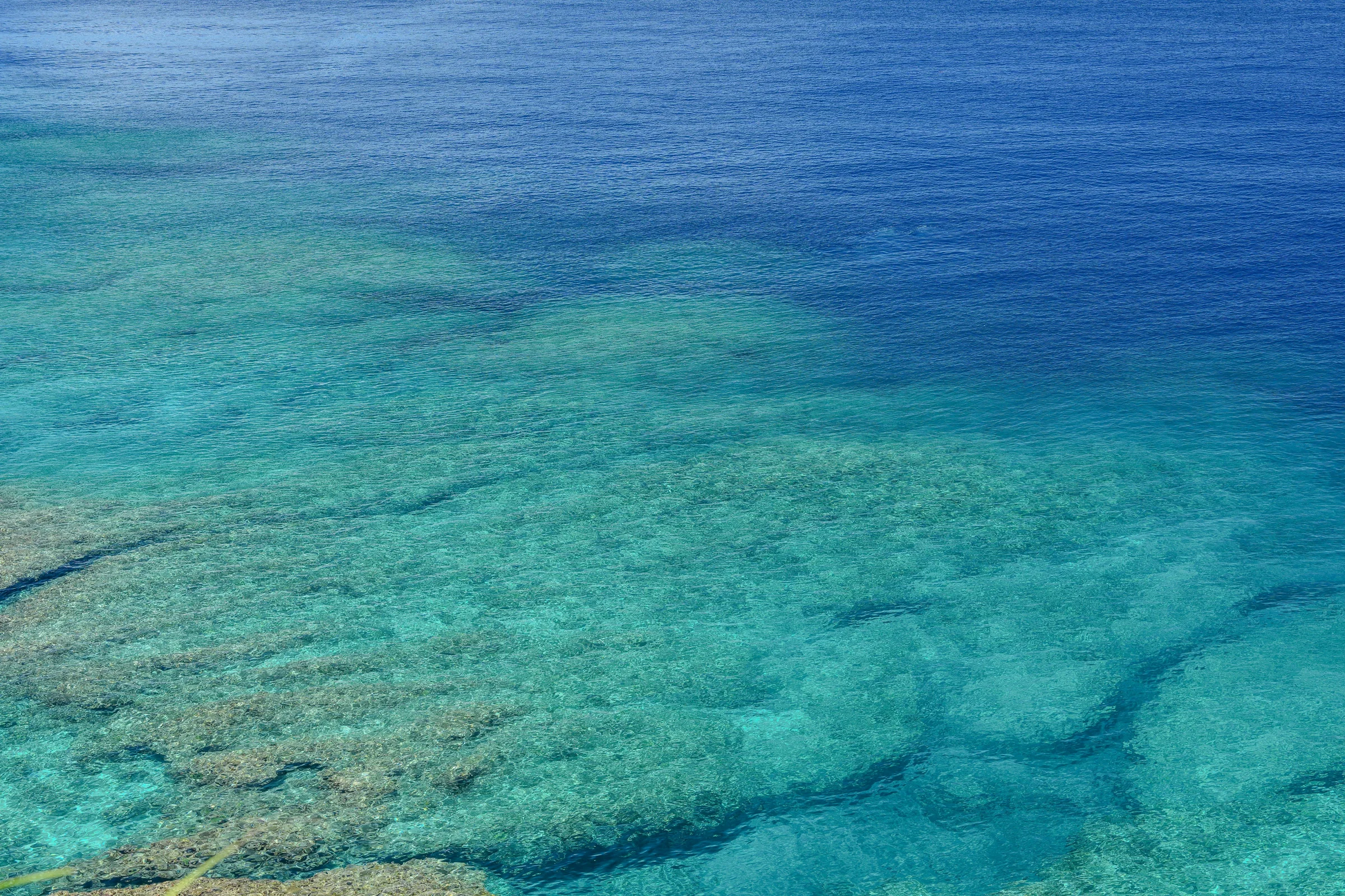 Aerial view of Kabira Bay on Ishigaki Island with turquoise water and lush coastline in Okinawa, Japan.