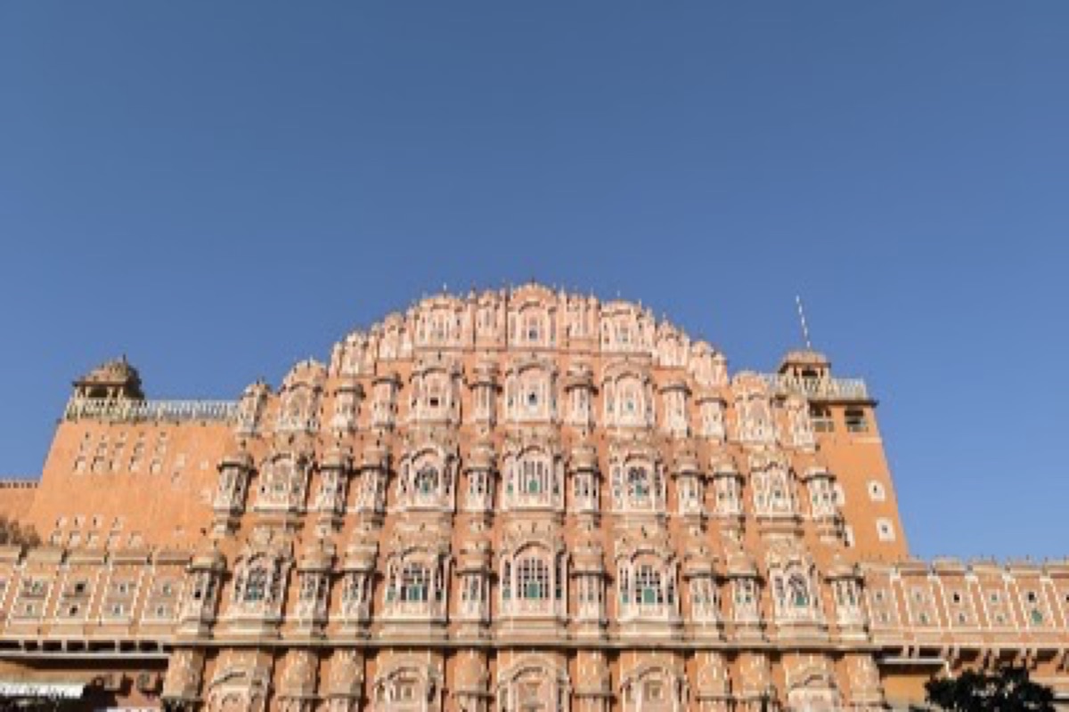 Hawa Mahal's ornate pink sandstone windows lit by soft morning light in Jaipur