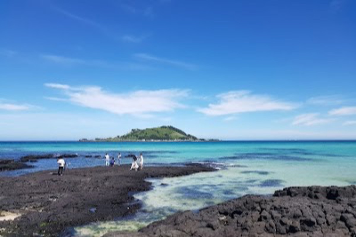 Hyeopjae Beach turquoise shallow waters with Biyangdo Island on Jeju's west coast