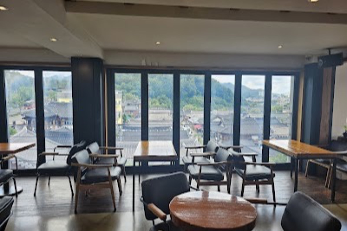Cafe Jeonmang rooftop panoramic view of Jeonju Hanok Village rooftops at golden hour