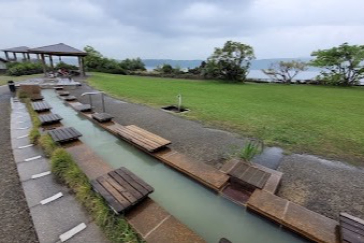 Sakurajima Yogan Nagisa Park volcanic foot bath with lava flow views across the waterfront