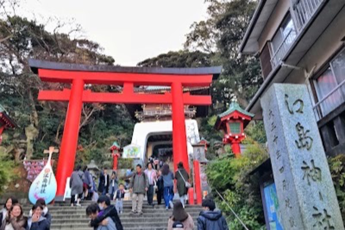 Enoshima Island sea-candle lighthouse overlooking the coast with Mount Fuji in the distance