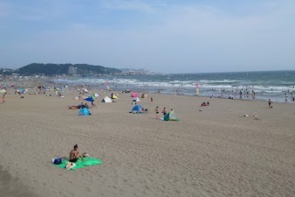 Yuigahama Beach at golden hour with Enoshima Island on the horizon