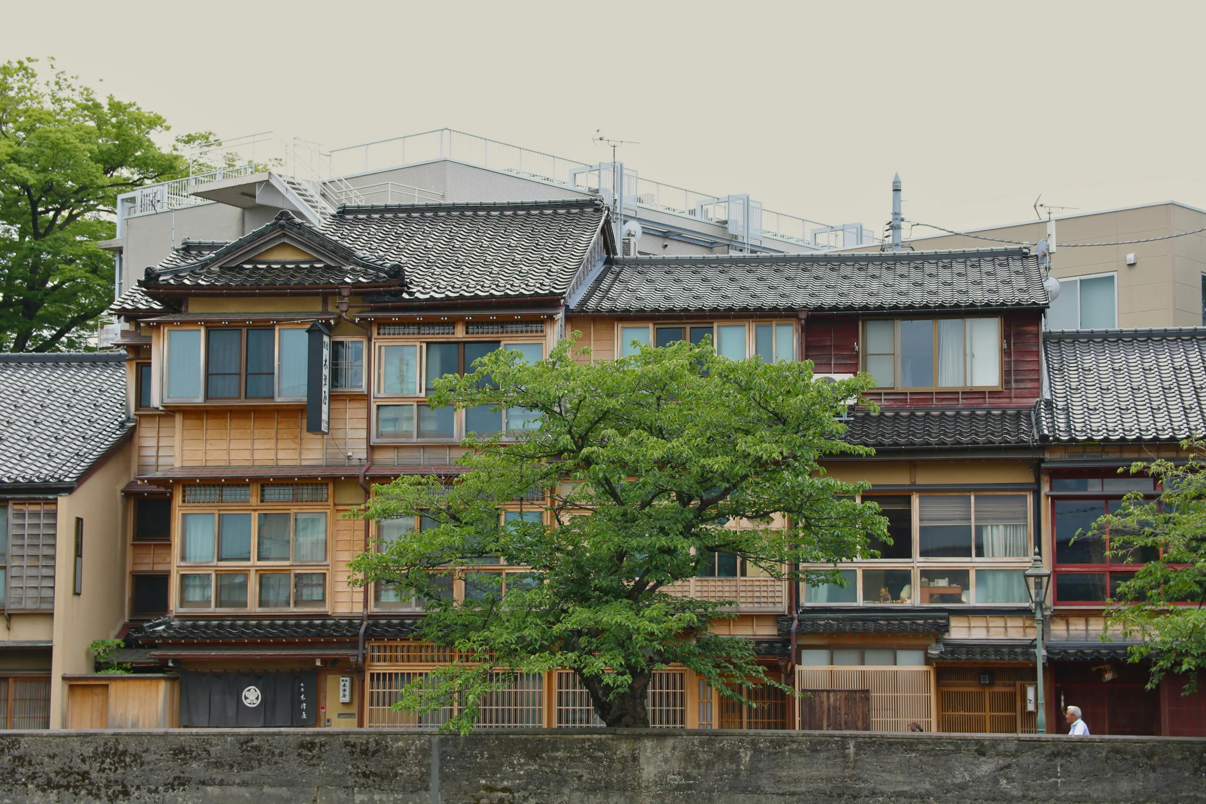 Evening street in Kanazawa, Japan with traditional wooden houses and lanterns