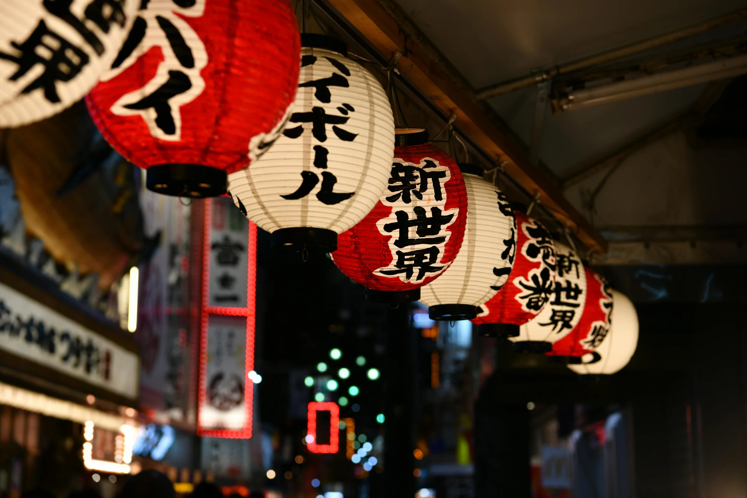 Evening street scene in Kanazawa, Japan with traditional wooden buildings and glowing lanterns