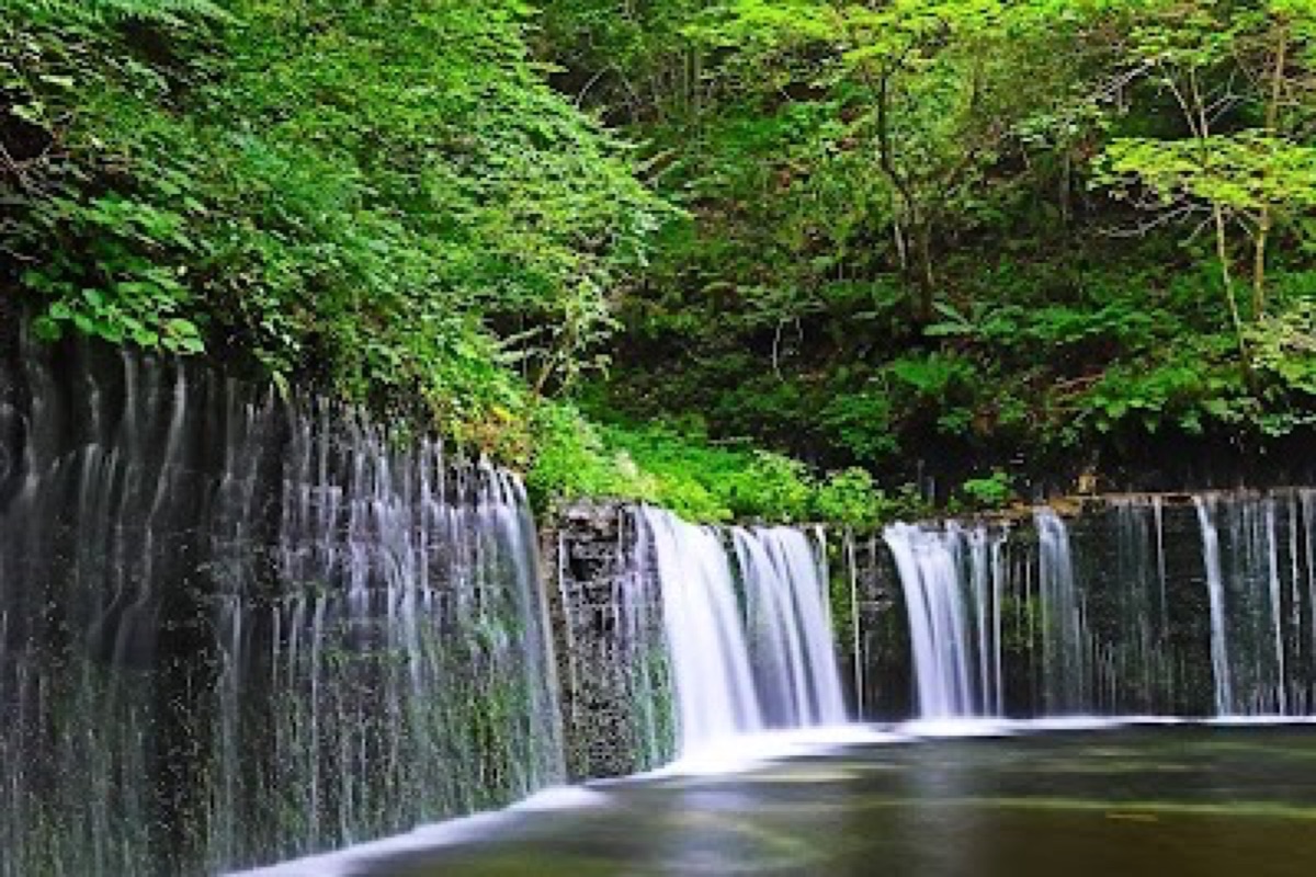 Shiraito Falls white-thread waterfalls cascading across a wide rock face in Karuizawa forest