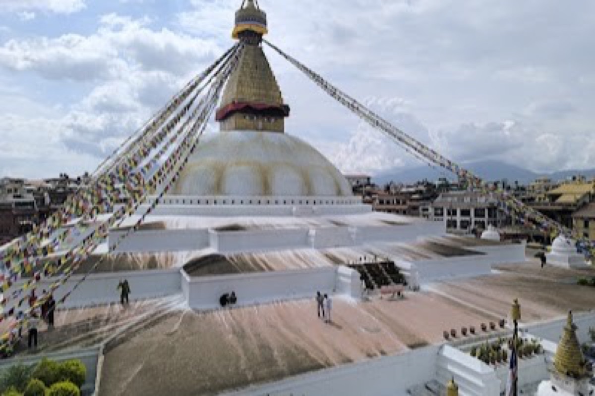 Butter lamps and prayer flags around the Boudhanath Stupa dome at dusk