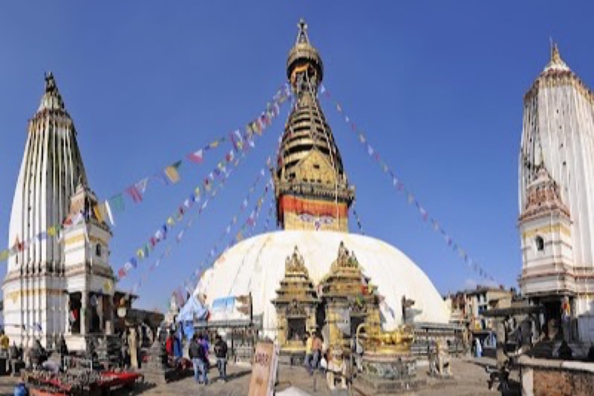 Swayambhunath stupa with prayer flags overlooking the Kathmandu Valley at sunset