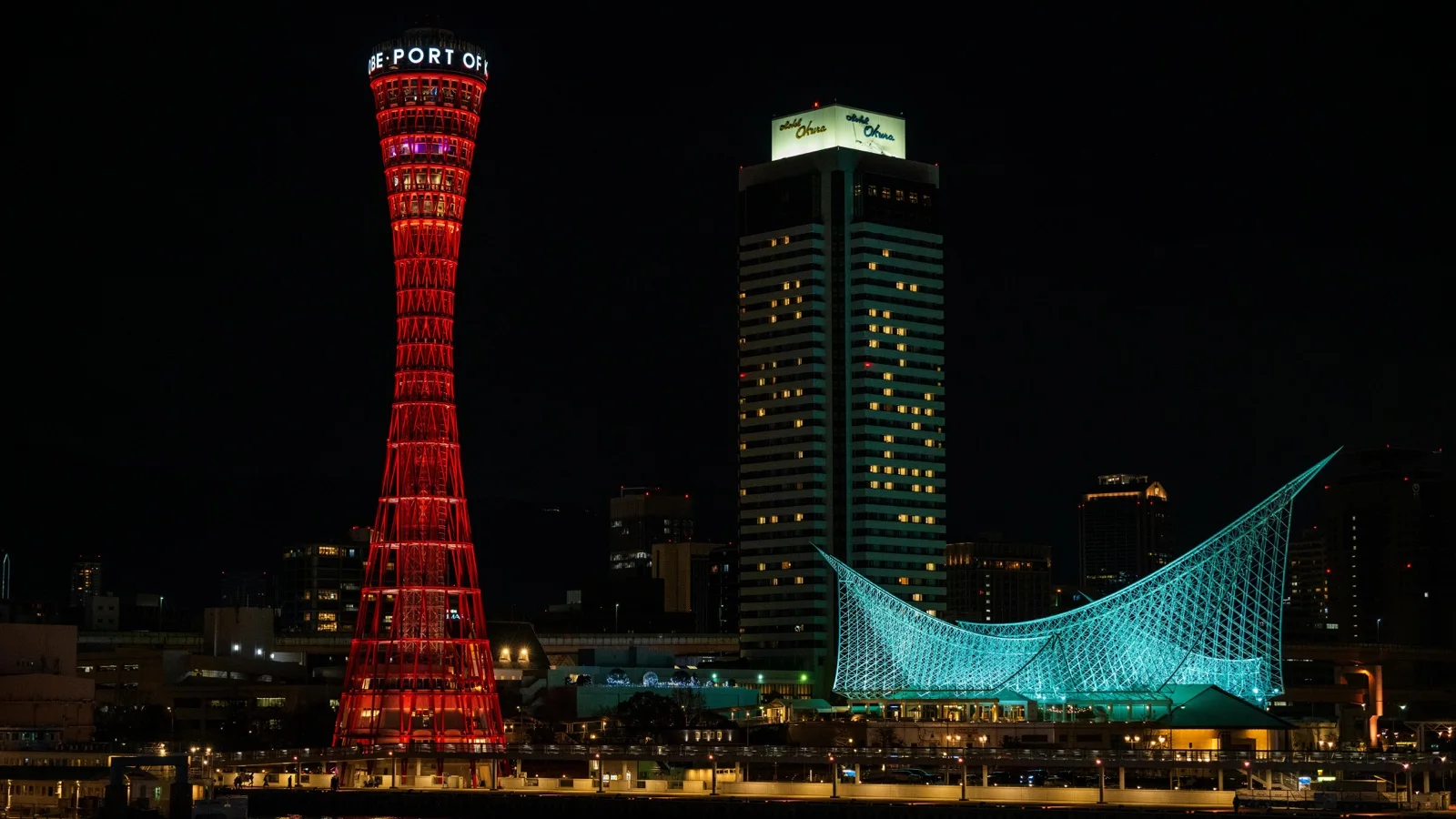 Kobe harbor at dusk with Port Tower and the city skyline reflected in the bay