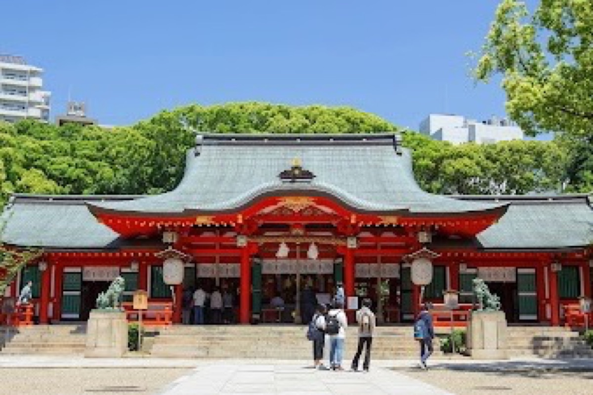 Ikuta Shrine torii gate surrounded by sacred camphor trees in central Kobe