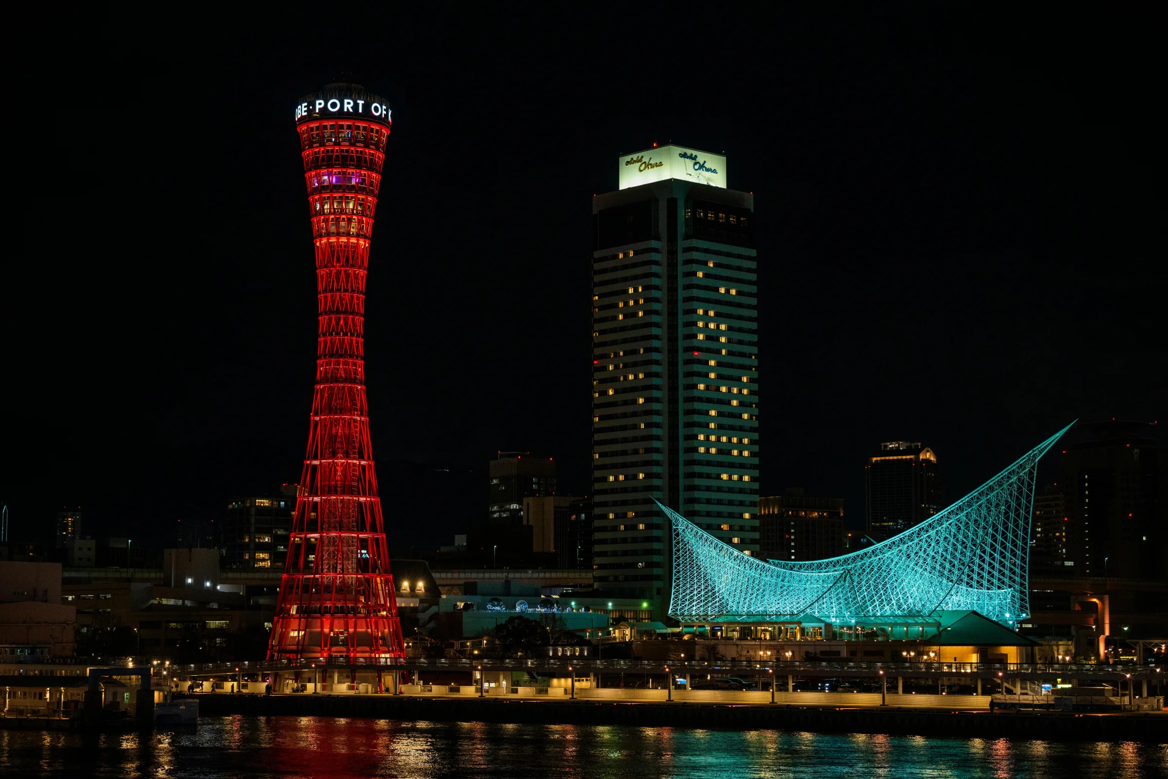 Sunset view of Kobe waterfront skyline with city lights and harbor