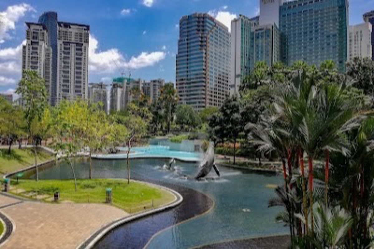 KLCC Park reflection pond mirroring the Petronas Twin Towers at dusk