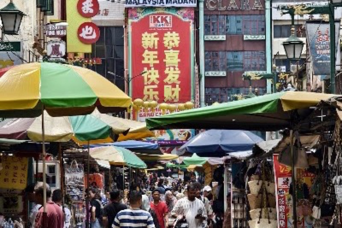 Petaling Street lanterns glowing over Chinatown night market stalls in Kuala Lumpur