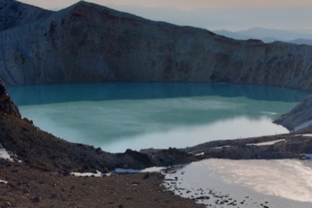 Yugama crater lake on Mt. Kusatsu-Shirane with turquoise acidic water and volcanic rock
