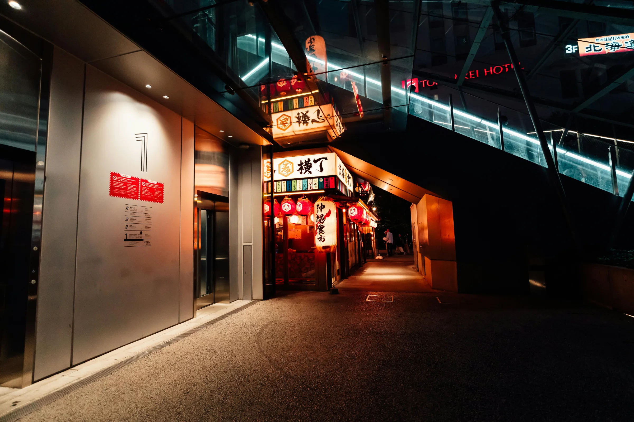 Traditional Kyoto street scene at dusk in Japan with lantern-lit buildings and pedestrians