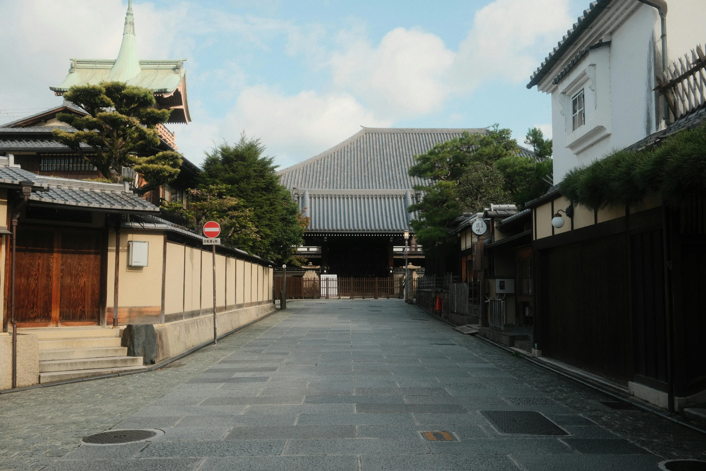 Traditional Kyoto street at dusk with temple architecture and lanterns