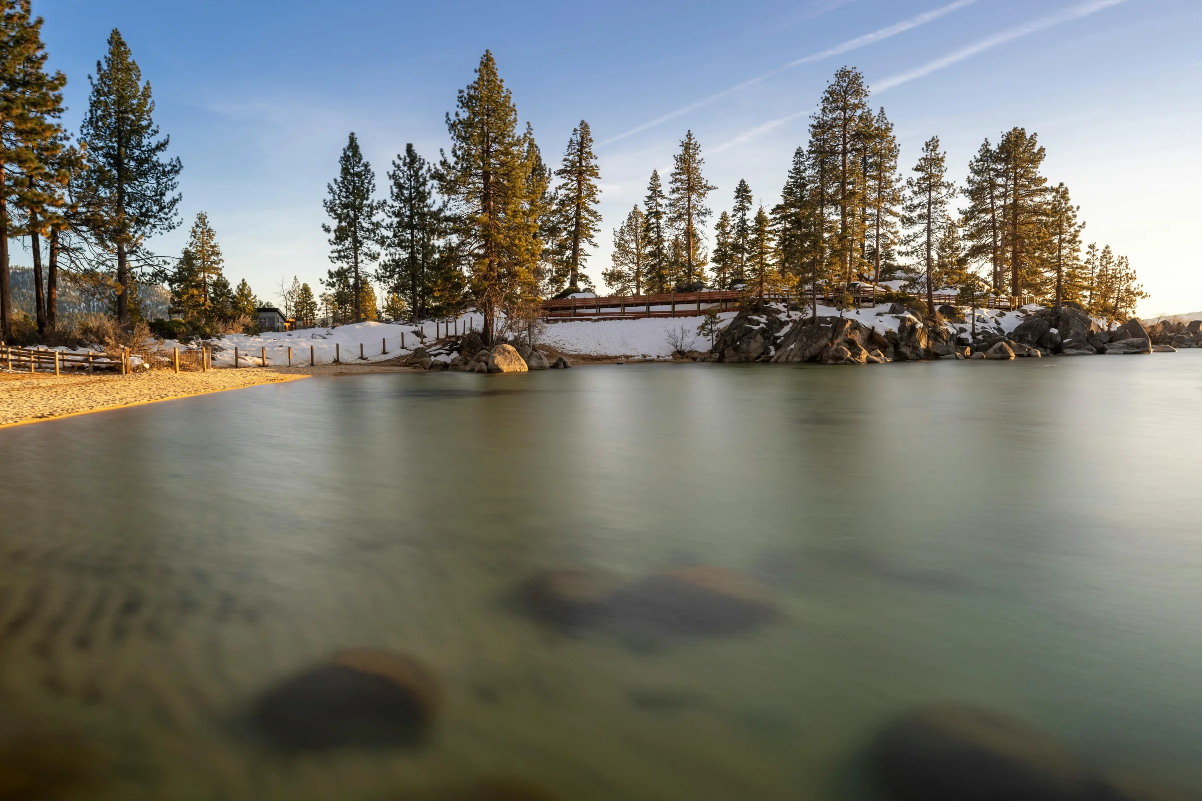 Wide panoramic view of Lake Tahoe with clear blue water and surrounding mountain peaks