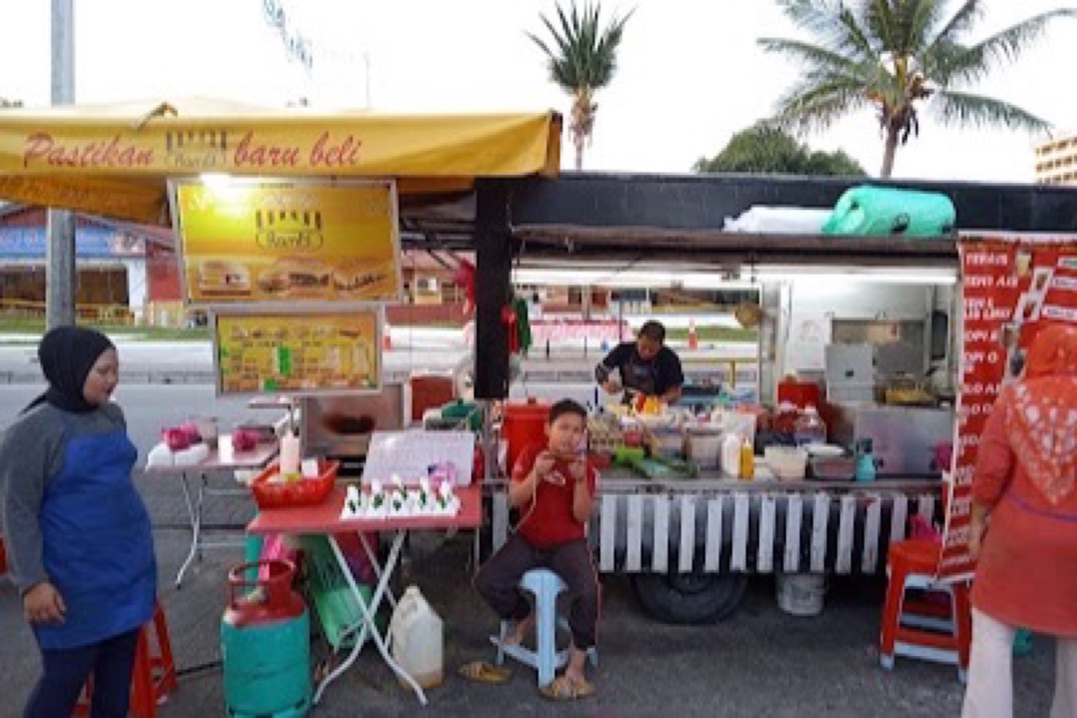 Langkawi night market stalls glowing with grilled chicken and street food under string lights