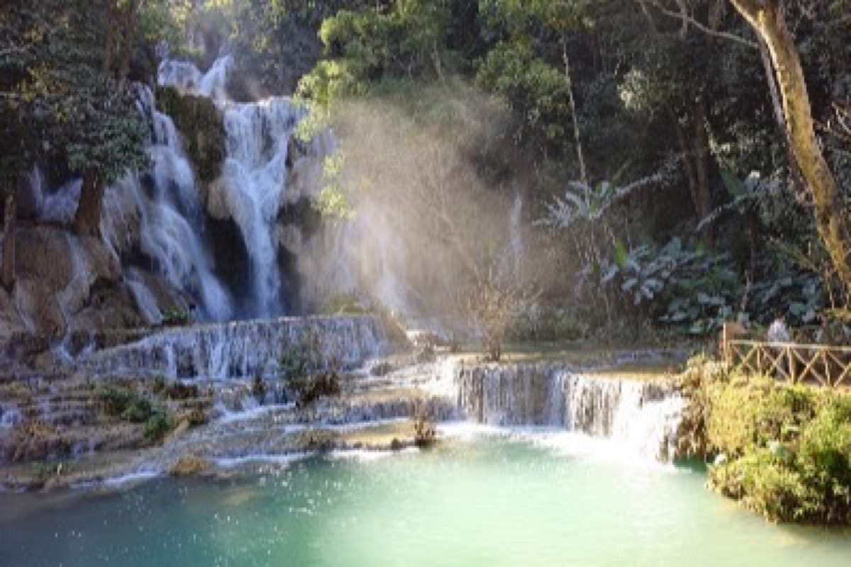 Turquoise travertine terraces of Kuang Si Falls framed by jungle south of Luang Prabang
