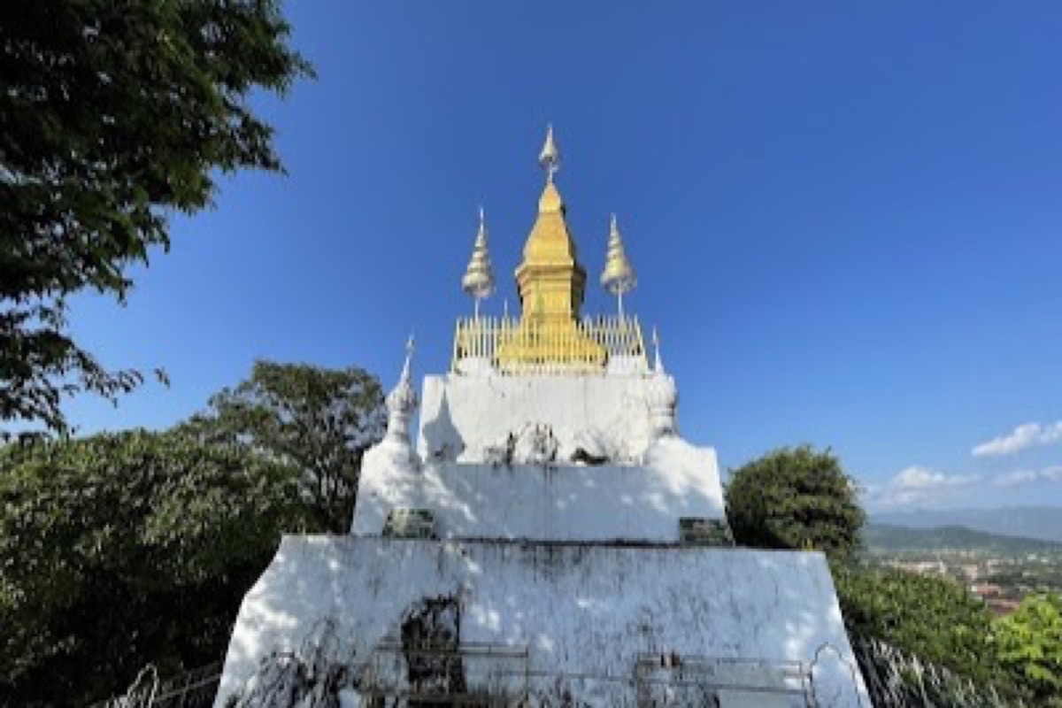 Golden stupa above Mount Phousi with panoramic sunset views over Luang Prabang and the Mekong