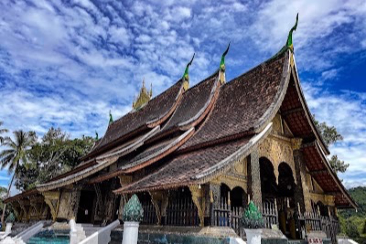 Wat Xieng Thong golden Tree of Life mosaic and tiered roofs in Luang Prabang